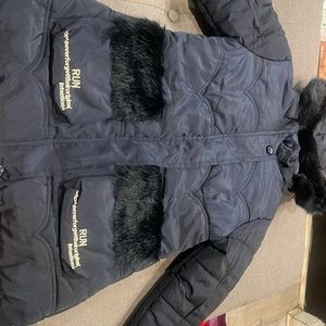 The color of the jacket is navy blue and has fuzzy pockets zip up  comfortable.